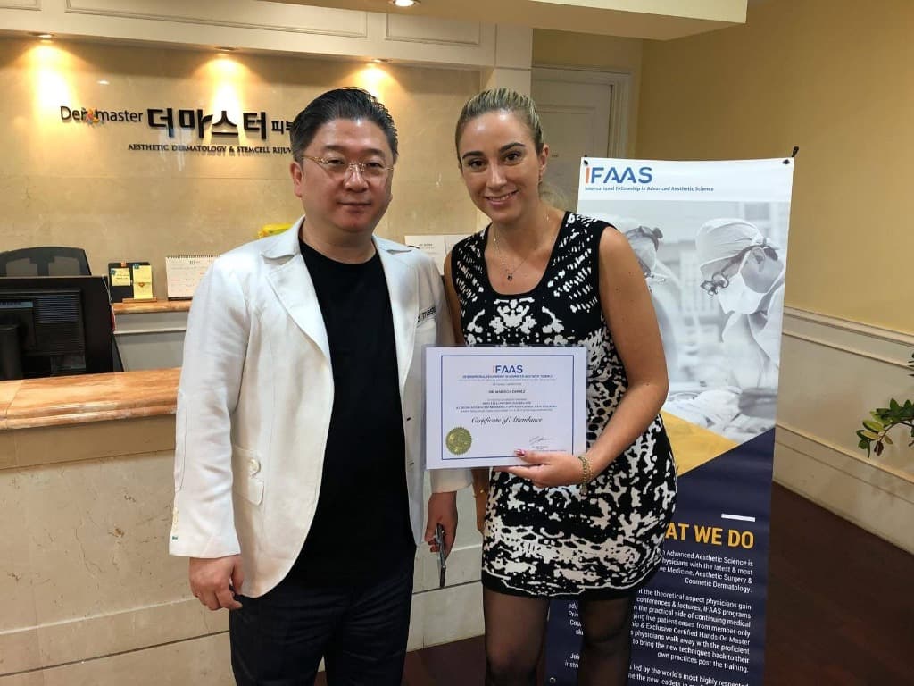 Dr. Marisol Gomez with a colleague, holding her IFAAS certificate.